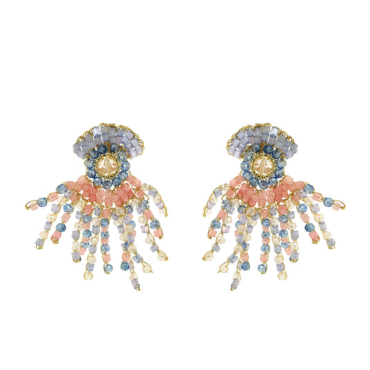 Pair of decorative earrings with floral and organic design and beads on a white background