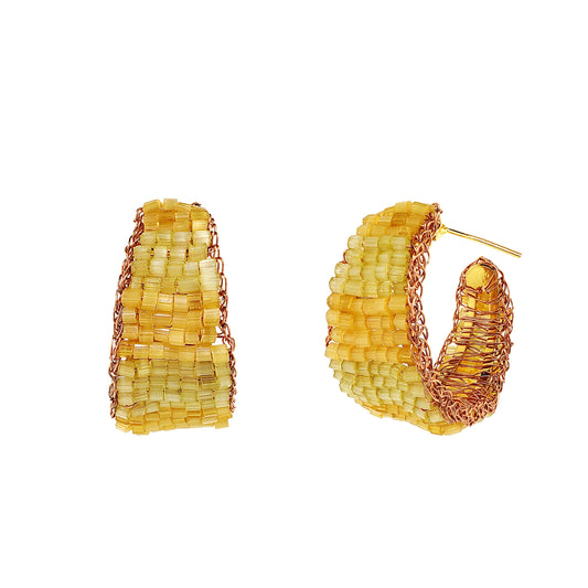 Pair of yellow hoop earrings on a white background