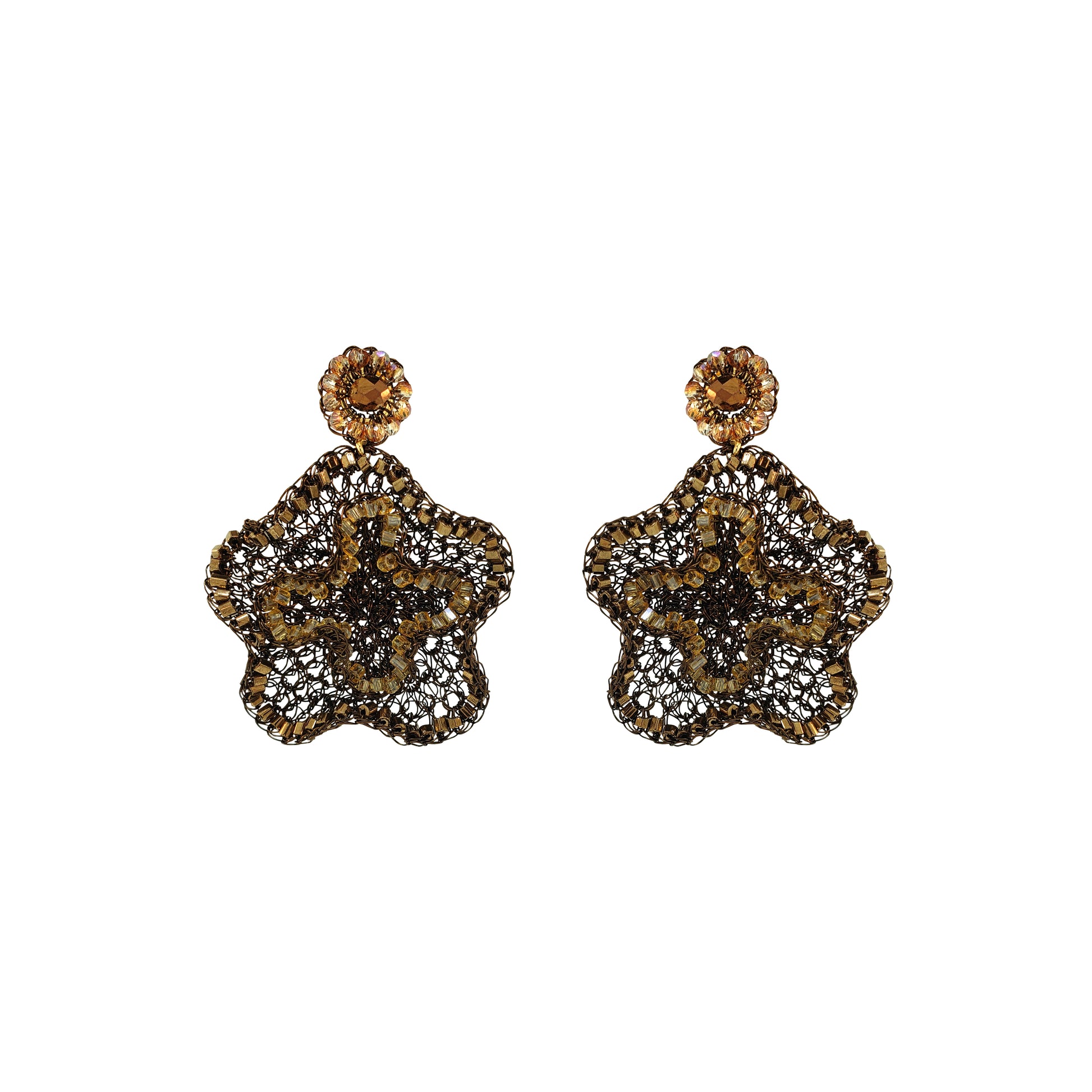 A pair of ornate dangle earrings with a gold-tone floral starburst design, heavily embellished with clear pavé stones and featuring a round amber-brown top stone, shown on a plain white background.