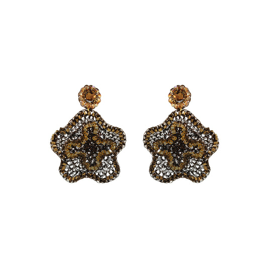 A pair of ornate dangle earrings with a gold-tone floral starburst design, heavily embellished with clear pavé stones and featuring a round amber-brown top stone, shown on a plain white background.