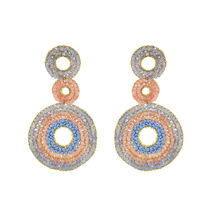 Pair of earrings with circular design on a white background