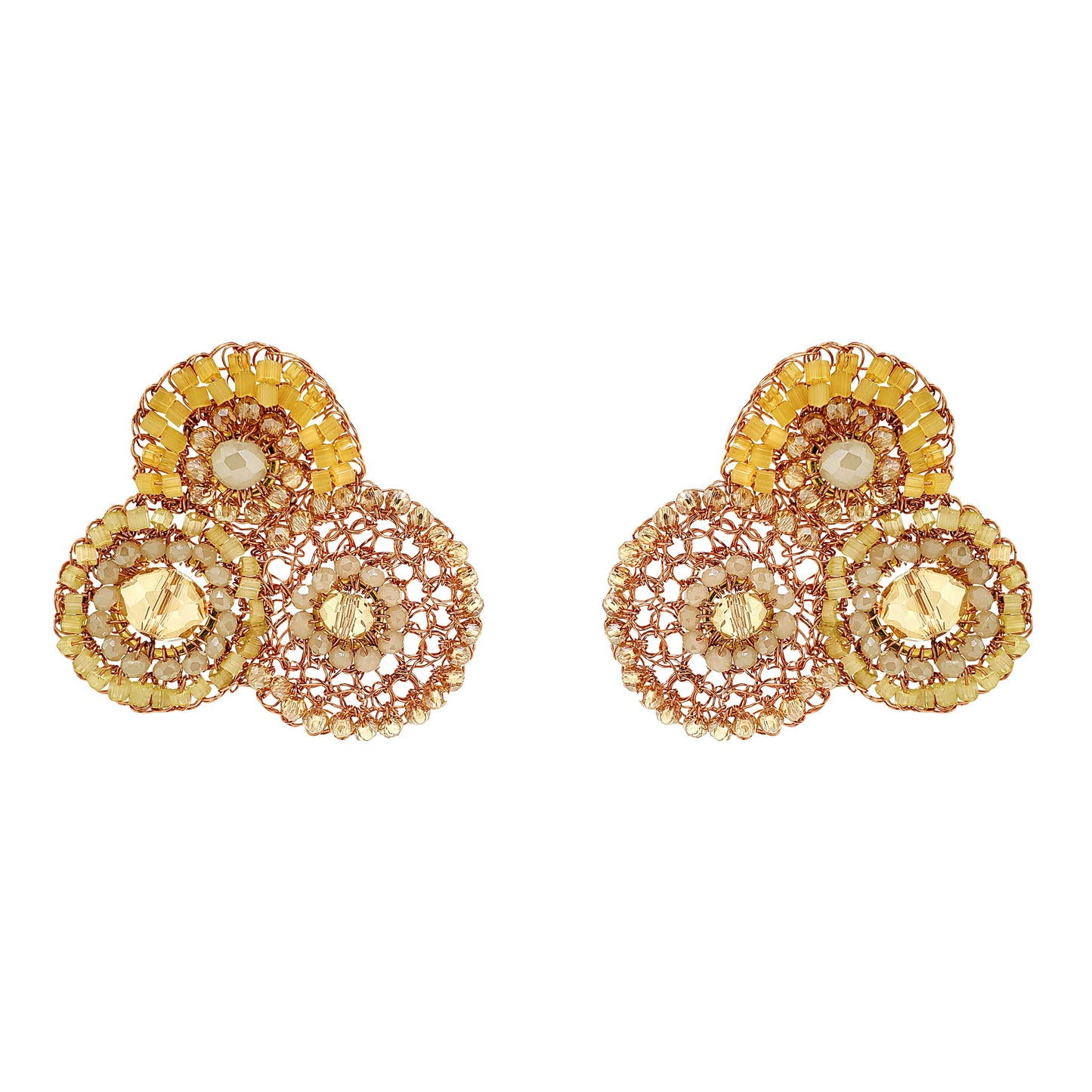 Pair of gold and rose gold earrings with circular designs on a white background