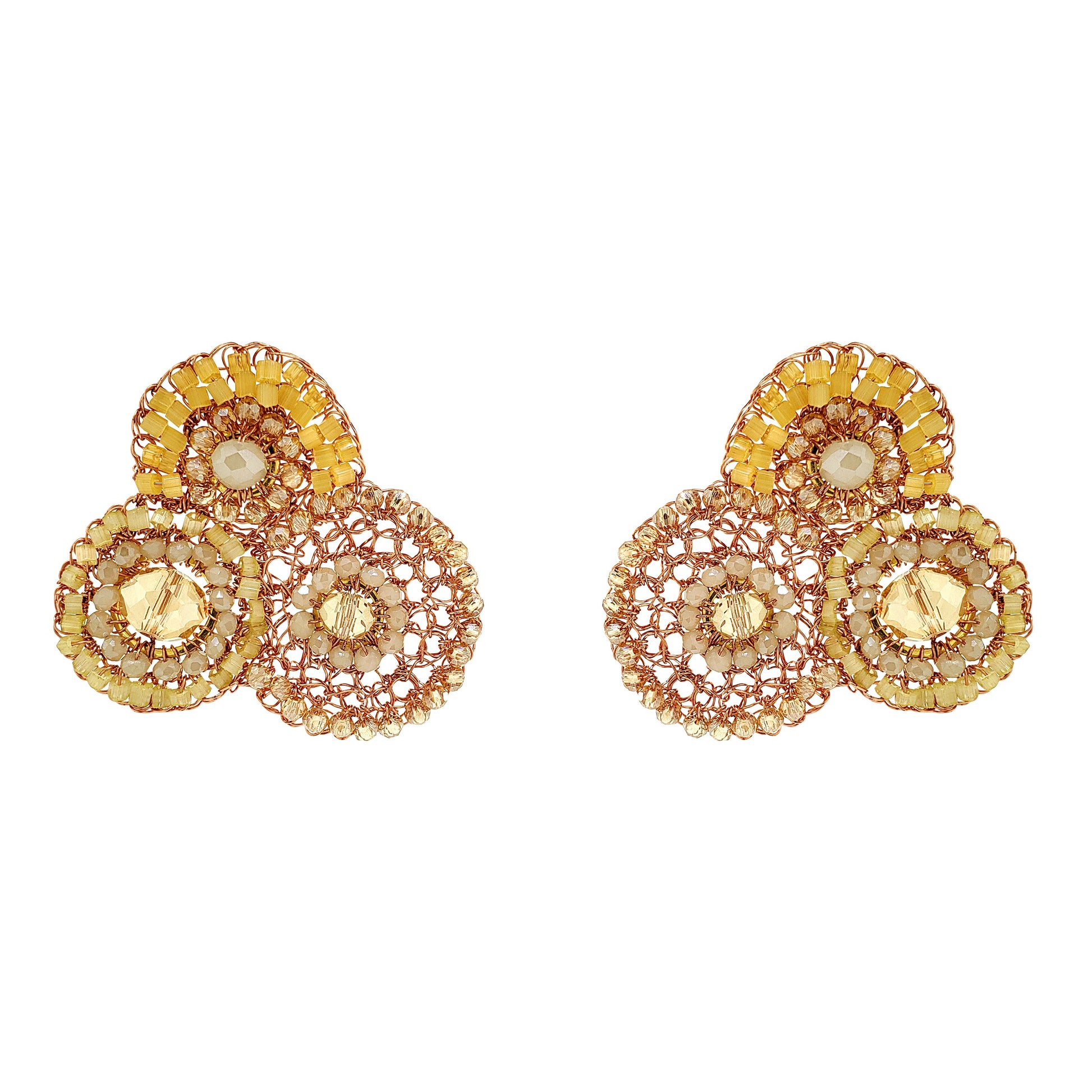Pair of gold and rose gold earrings with circular designs on a white background