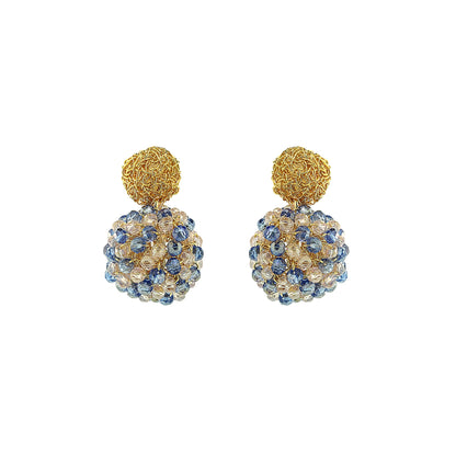 Pair of gold and blue spherical earrings on a white background