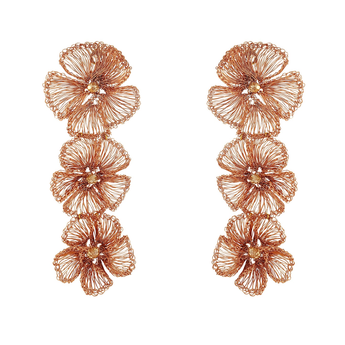 Pair of rose gold floral earrings on a white background