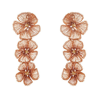 Pair of rose gold floral earrings on a white background