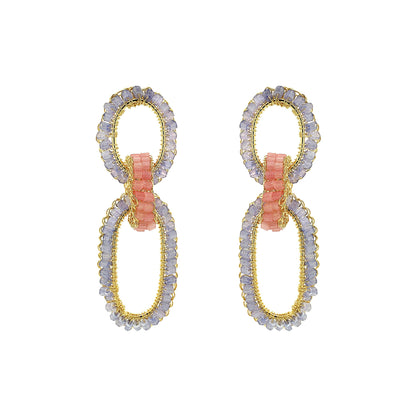 Pair of earrings with gold and silver loops on a white background