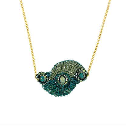 Gold necklace with a green and gold pendant on a white background
