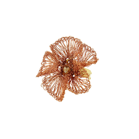 Copper flower-shaped jewelry piece ring on a white background