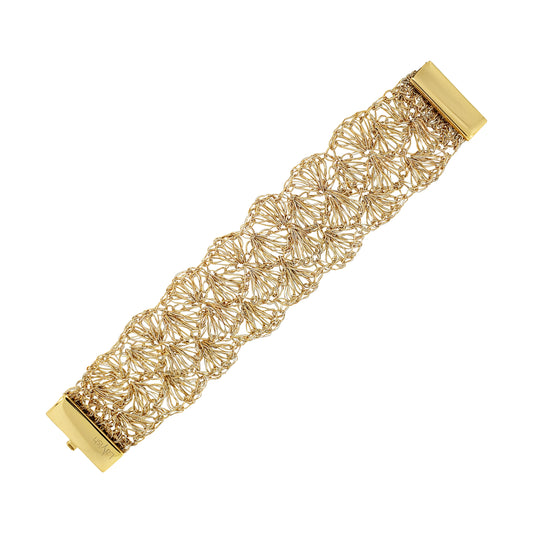 Gold bracelet with intricate design on a white background