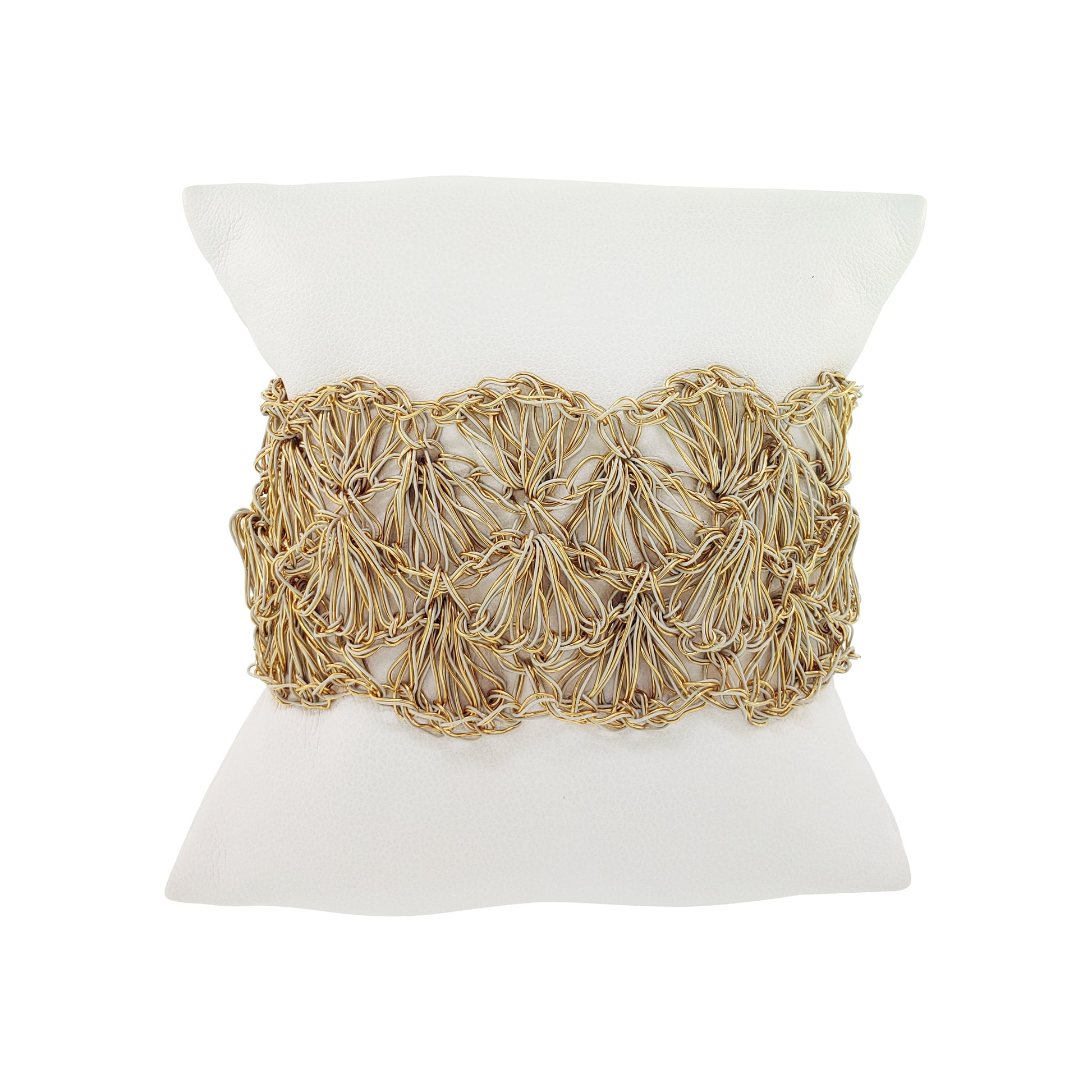 Decorative pillow with gold woven pattern on a white background