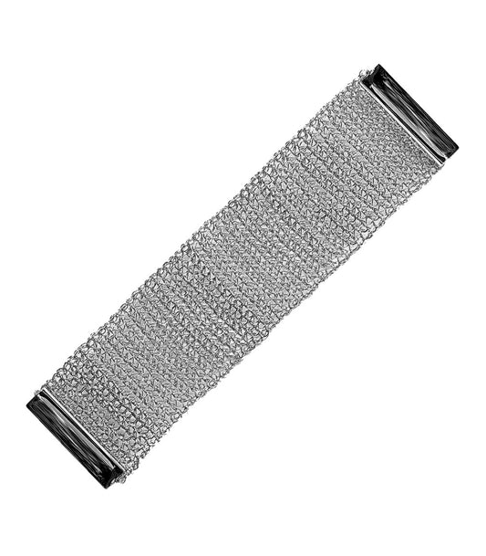 A hand-crocheted gunmetal copper wire bracelet with a mesh pattern and a magnetic clasp. Hand-crocheted gunmetal cuff bracelet handmade in Brazil with intricate crochet texture, sleek silver-tone shine, and matching magnetic closures.