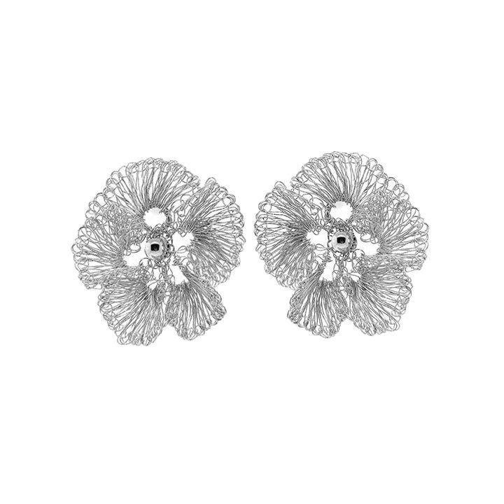 Pair of silver floral earrings on a white background