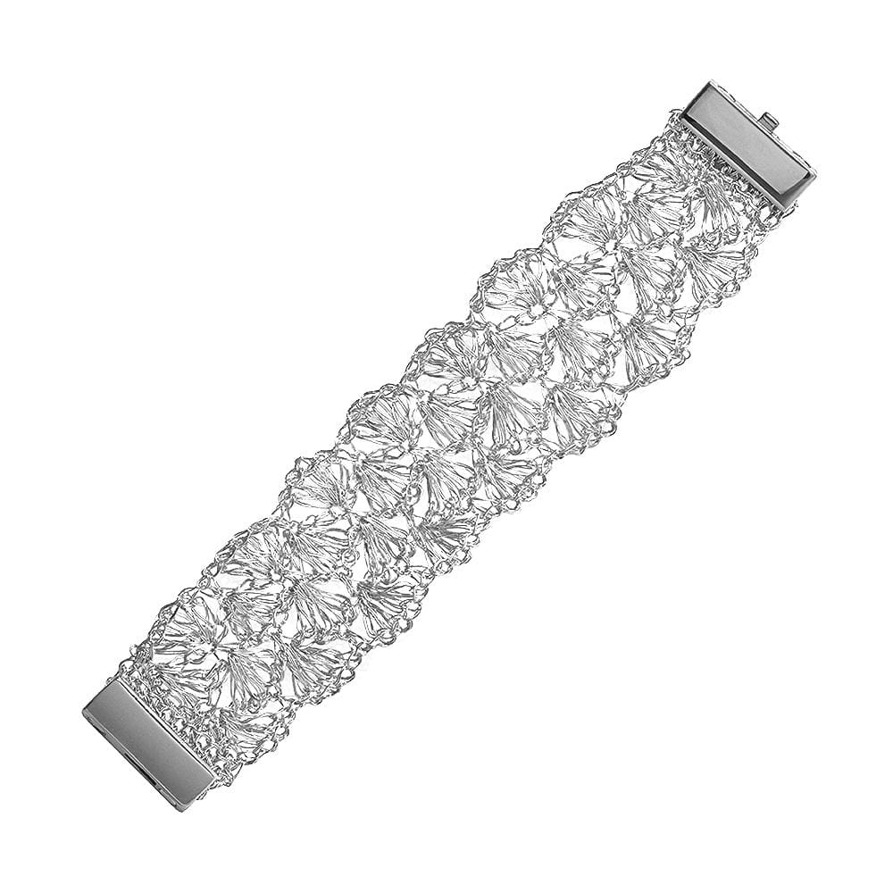 A silver-colored cuff bracelet with hand-crocheted wire work resembling shells, featuring a magnetic clasp.