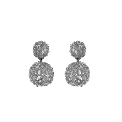 A pair of hand-crocheted silver earrings with a spherical design, displayed against a white background.