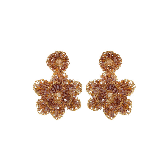 A pair of hand-crocheted earrings made with gold and amber colored yarn, designed in a floral pattern. Mini floral hand-crocheted earrings handmade in Brazil with 18 karat gold filled wire, lightweight artisan floral design, and delicate gold texture.