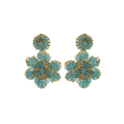 A pair of hand-crocheted earrings featuring blue and gold floral patterns, made with 18 karat gold filled wire. Mini floral hand crocheted earrings in 18 karat gold filled wire, lightweight hypoallergenic Brazilian artisan jewelry with feminine floral design.