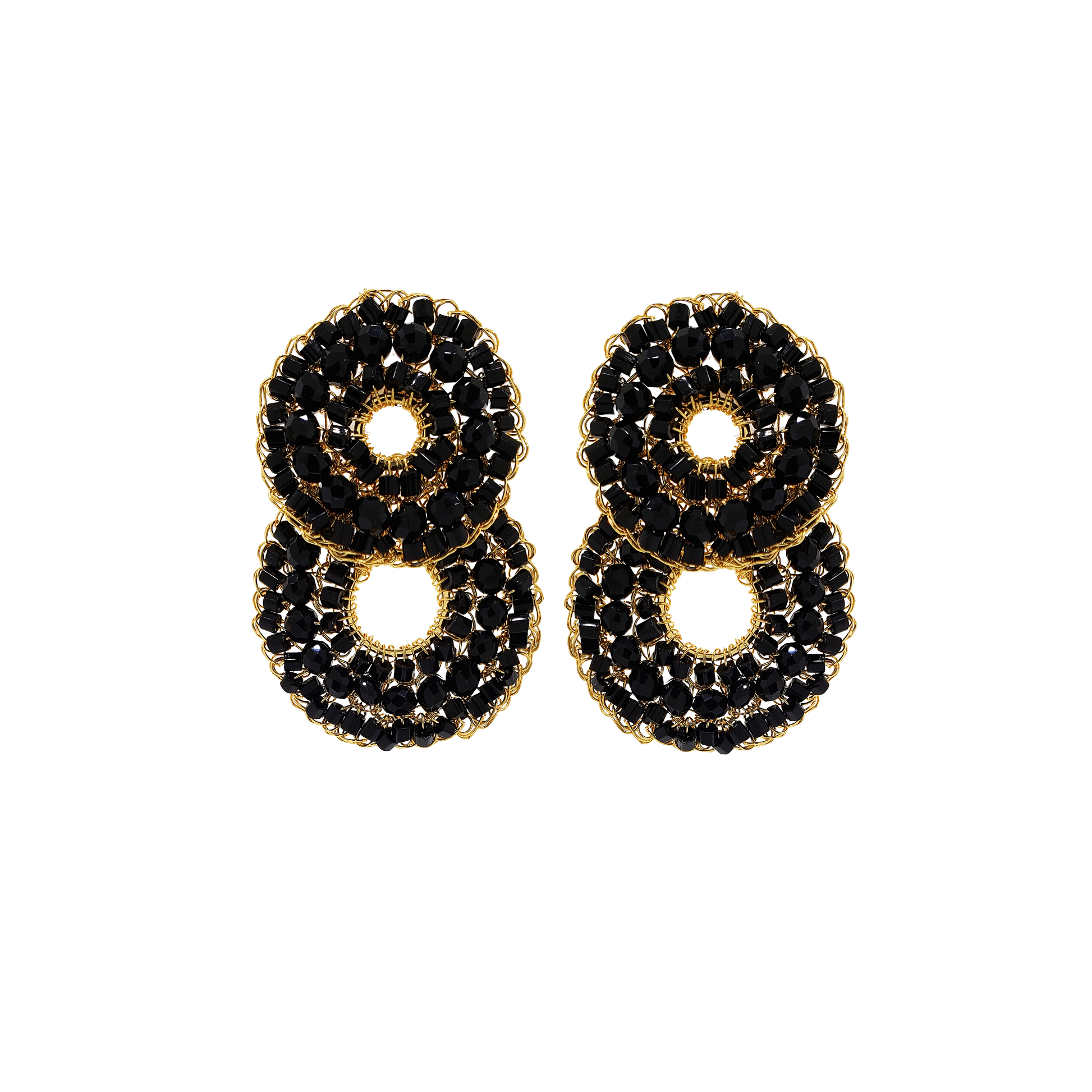 Pair of earrings with black stones and gold accents on a white background