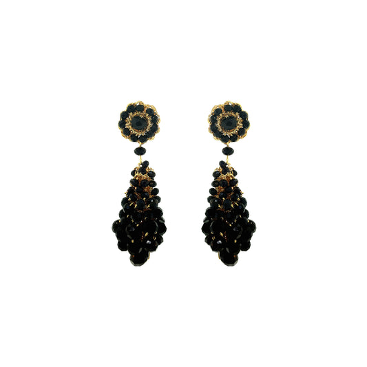 Pair of black and gold earrings on a white background. Hand-crocheted statement earrings made in Brazil with 18 karat gold filled wire and sparkling bead accents.