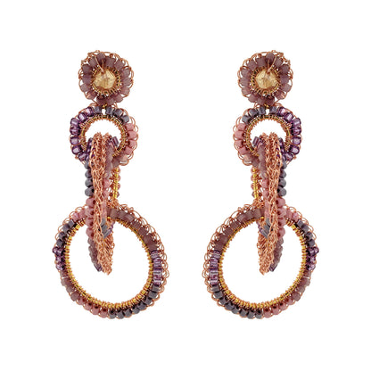 A pair of hand-crocheted earrings with 18 karat rose gold filled wire and multicolored beads and crystals. Interlocked link hand-crocheted earrings handmade in Brazil with 18 karat rose gold filled wire, blush, mauve, and lavender bead accents, sparkling crystals, and layered circular links.