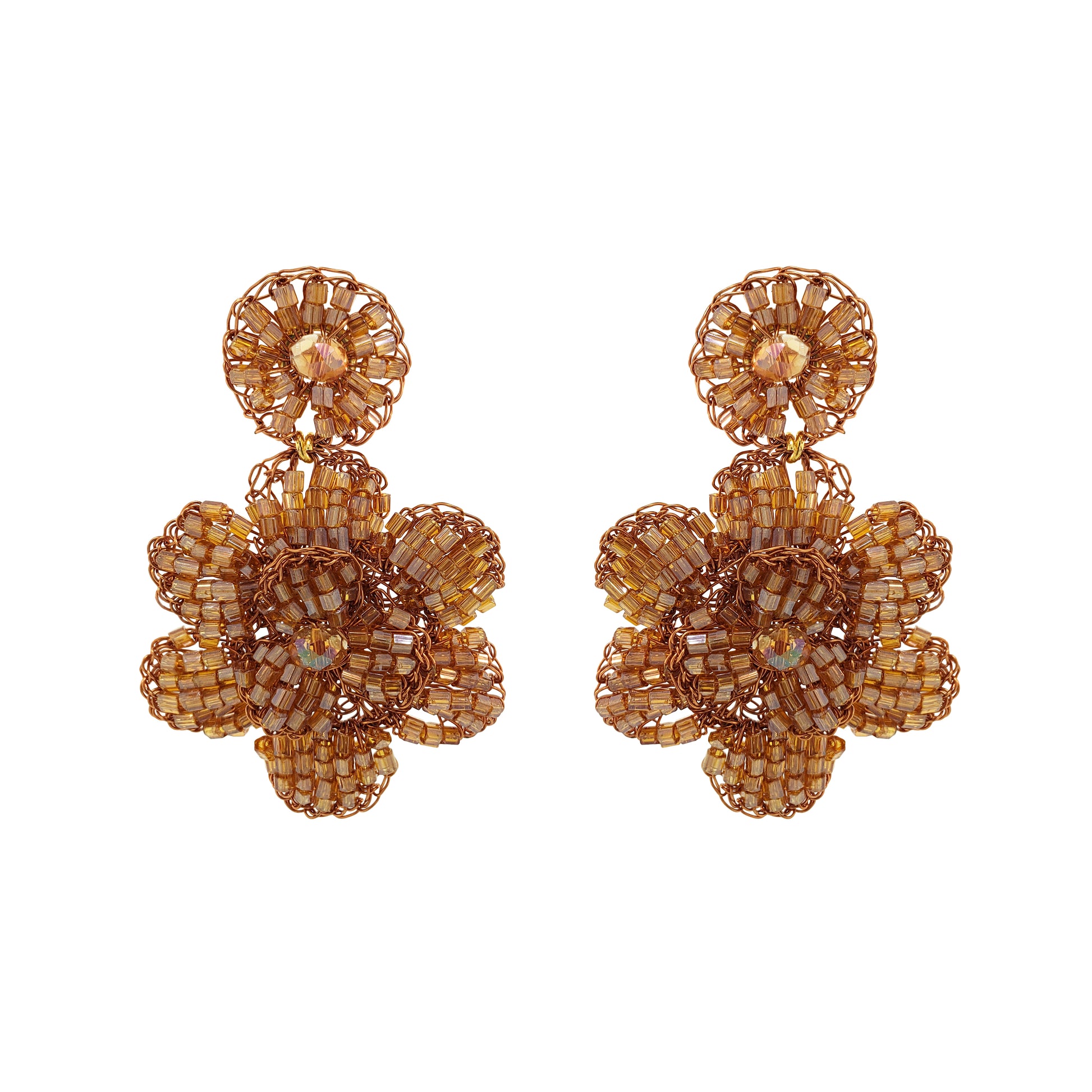 Pair of gold floral earrings on a white background. Mini floral hand-crocheted earrings handmade in Brazil with bronze enameled wire and amber bead accents.