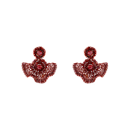 A pair of red angel-themed stud earrings featuring a central red gemstone surrounded by smaller sparkling red and clear stones, set against a plain white background.