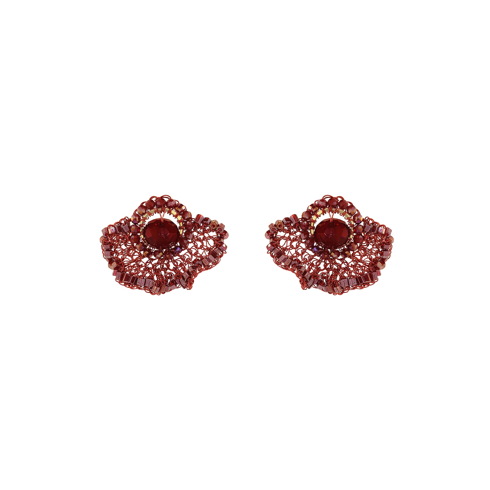A pair of textured, scalloped red earrings with a central oval red stone, set against a plain white background. Shop Burgundy Mix Celosia Post Earrings, featuring a hand-crocheted fan design with shimmering crystals and beads. Lightweight and handmade in Brazil.