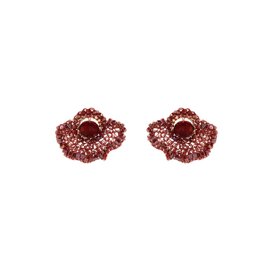 A pair of textured, scalloped red earrings with a central oval red stone, set against a plain white background. Shop Burgundy Mix Celosia Post Earrings, featuring a hand-crocheted fan design with shimmering crystals and beads. Lightweight and handmade in Brazil.