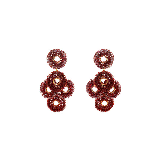 A pair of drop earrings made of multiple stacked circular crystal clusters in a deep burgundy-red hue, set against a plain white background. Shop Burgundy Mix Coco Earrings, handcrafted in Brazil with 18K gold filled and enameled wire. Lightweight crystal statement earrings in rich burgundy tones.