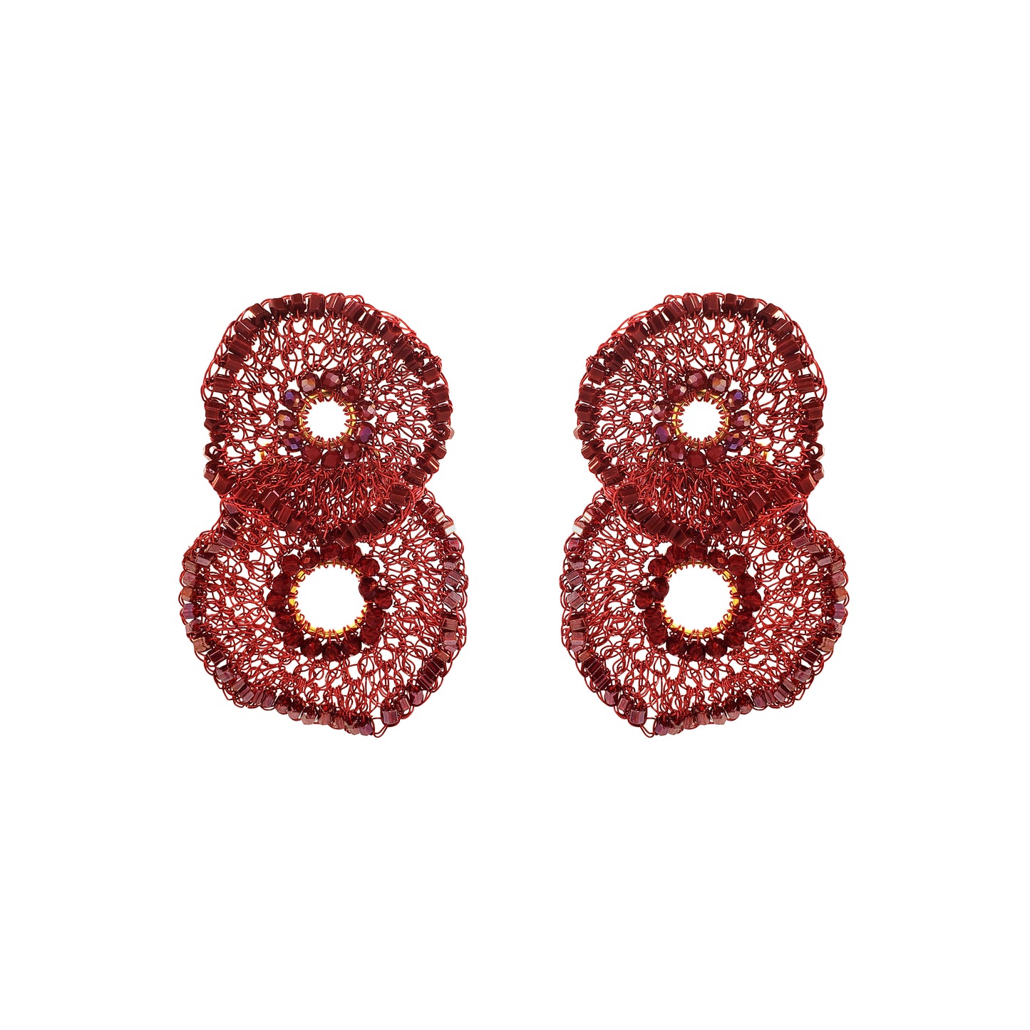 A pair of textured, glittery red earrings shaped like stylized numbers 8, displayed on a clean white background. Shop the Crista Duo Earrings, hand-crocheted in Brazil with rich burgundy tones, shimmering bead accents and a lightweight double-circle design.