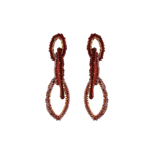 A pair of beaded drop earrings with a textured, looped design in deep red and brown tones, set against a plain white background. Shop the Burgundy Mix Demi Earrings, featuring three cascading hand-crocheted links with shimmering bead accents. Lightweight and handmade in Brazil.
