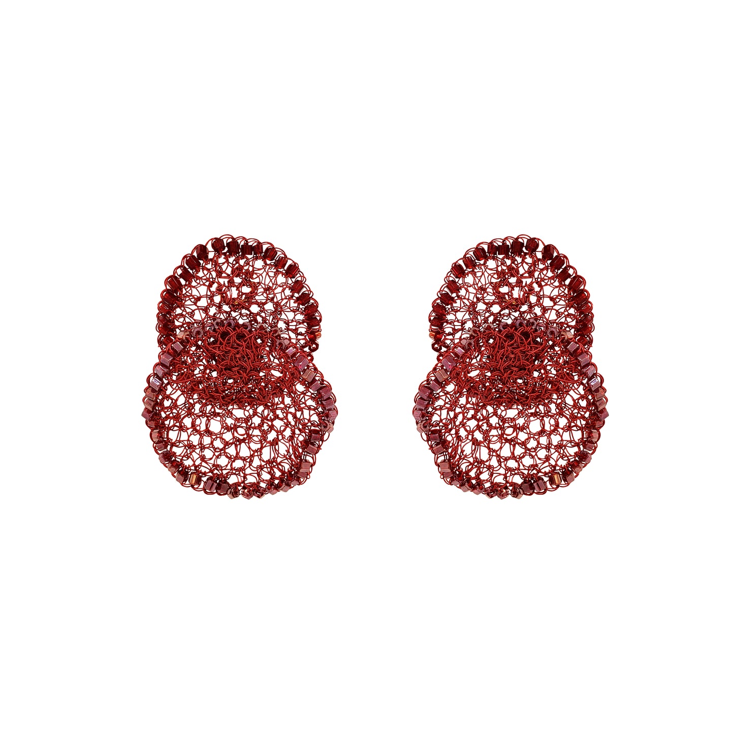 Pair of red textured earrings on a white background. Hand-crocheted red statement earrings with layered circular design, sparkling bead accents, and enameled wire, handmade in Brazil.