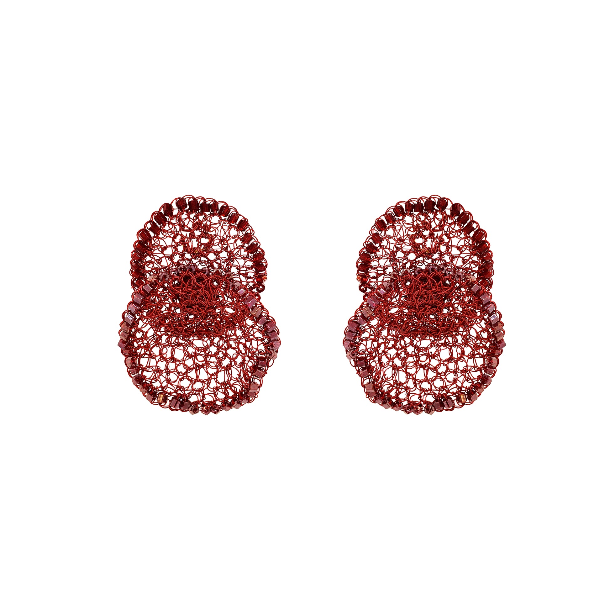 Pair of red textured earrings on a white background. Hand-crocheted red statement earrings with layered circular design, sparkling bead accents, and enameled wire, handmade in Brazil.