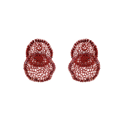 Pair of red textured earrings on a white background. Hand-crocheted red statement earrings with layered circular design, sparkling bead accents, and enameled wire, handmade in Brazil.