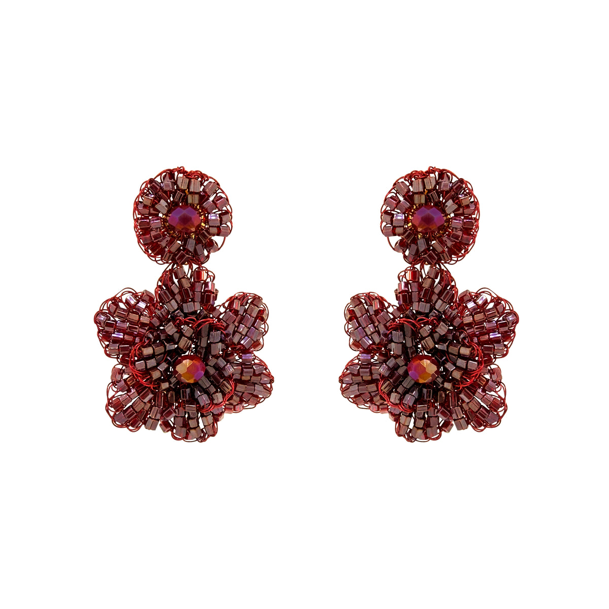 A pair of handmade beaded flower drop earrings in deep burgundy red with small faceted purple and iridescent center stones, displayed on a clean white background. Shop Burgundy Mix Mini Blossom Earrings, featuring dimensional hand-crocheted flowers with shimmering crystals and beads. Lightweight and handmade in Brazil.