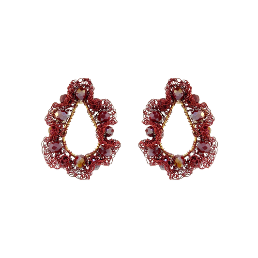 A pair of ornate teardrop-shaped earrings made of red wire mesh with small faceted beads in red, purple, and gold, displayed on a clean white background. Shop Burgundy Mix Nalu Teardrop Earrings, featuring ruffled hand-crocheted details and sparkling beads. Lightweight and handcrafted in Brazil. 