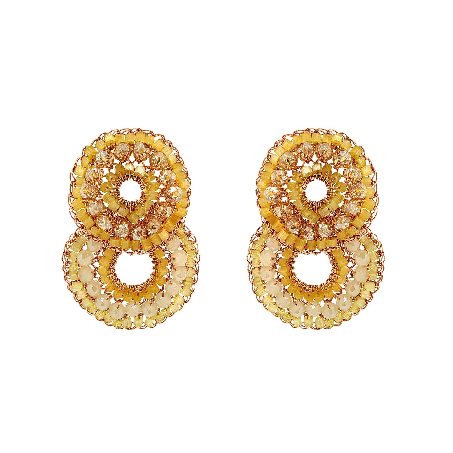 Pair of gold circular earrings on a white background. Hand-crocheted double-circle cascade earrings with sparkling crystals and glass beads, handmade in Brazil with enameled copper wire.