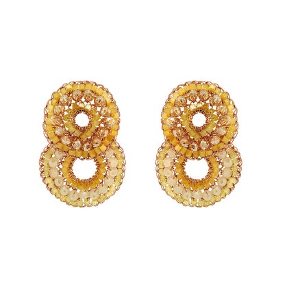 Pair of gold circular earrings on a white background. Hand-crocheted double-circle cascade earrings with sparkling crystals and glass beads, handmade in Brazil with enameled copper wire.