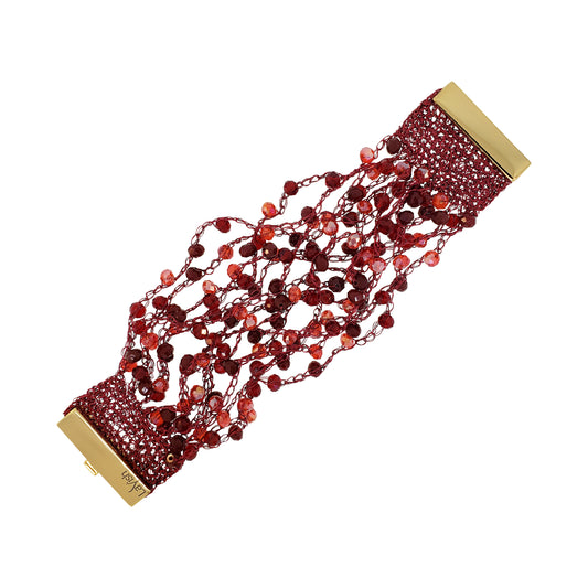 Red beaded bracelet with gold clasps on a white background.Hand-crocheted cherry red cuff bracelet handmade in Brazil with deep red enameled wire, sparkling red crystal accents, and gold-tone magnetic closures.