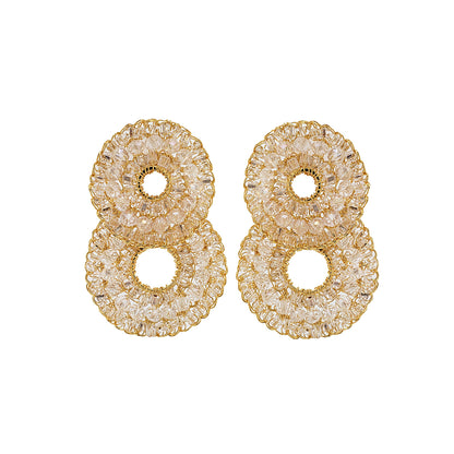 A pair of gold-colored, double-shaped cascade earrings with clear crystals, created through hand crocheting.