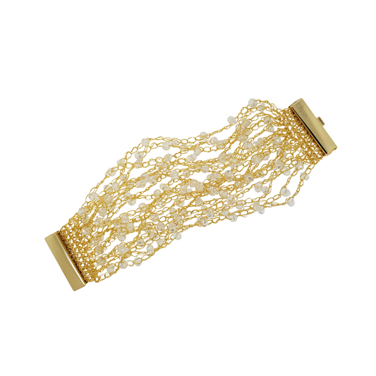 A hand-crocheted gold-colored cuff bracelet with multiple strings and sparkling beads, secured by a magnetic clasp. Hand-crocheted gold cuff bracelet handmade in Brazil with 18 karat gold filled wire, sparkling clear crystal accents, and magnetic clasp.