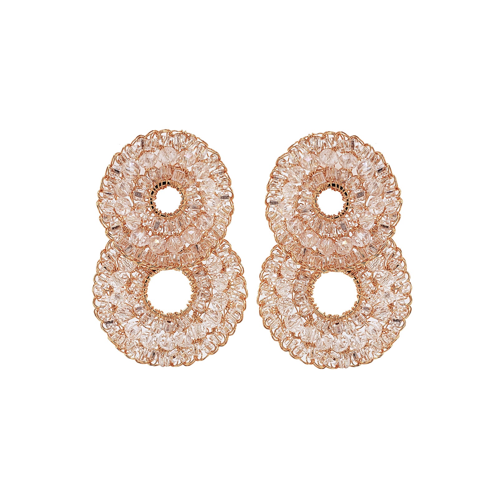 Pair of rose gold earrings with intricate designs on a white background