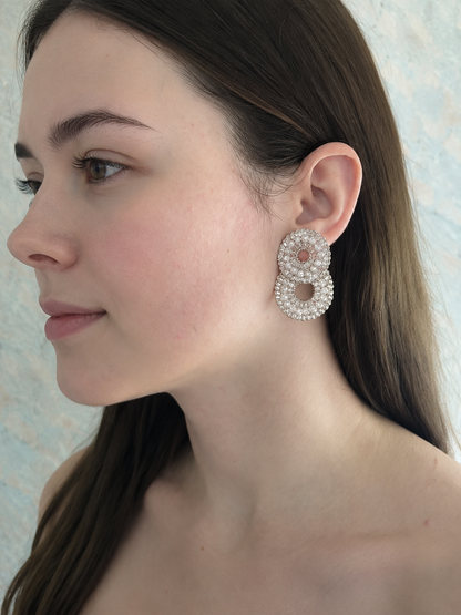 Clear and Silver hand-crocheted double-circle cascade earrings with sparkling crystals and glass beads, handmade in Brazil with palladium wire.