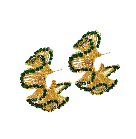 A pair of hand-crocheted hoop earrings with green and gold patterns, made with 18k gold filled wire. Green and Gold Rio Hoop handmade crochet earrings featuring sculptural ruffled 18K gold-filled wire accented with rich dark green crystals.