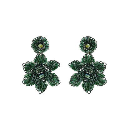 A pair of hand-crocheted floral earrings in moss green enameled wire on a white background. Mini floral hand-crocheted dangle earrings handmade in Brazil with shiny enameled wire and deep moss green bead accents.