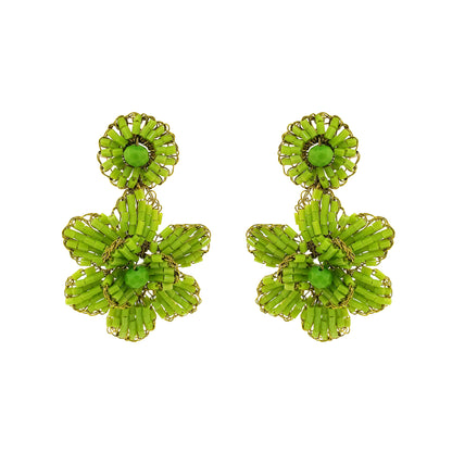 A pair of neon green mini blossom handcrafted crochet earrings. Mini floral hand-crocheted dangle earrings handmade in Brazil with shiny enameled wire and vibrant neon green bead accents.