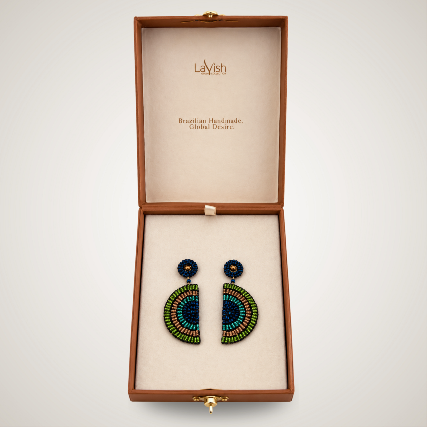 A pair of handmade beaded earrings displayed inside an open brown presentation box with a cream-colored interior. The earrings feature a semicircle design with blue, green, and orange-red beads, and a small round blue bead stud on top.
