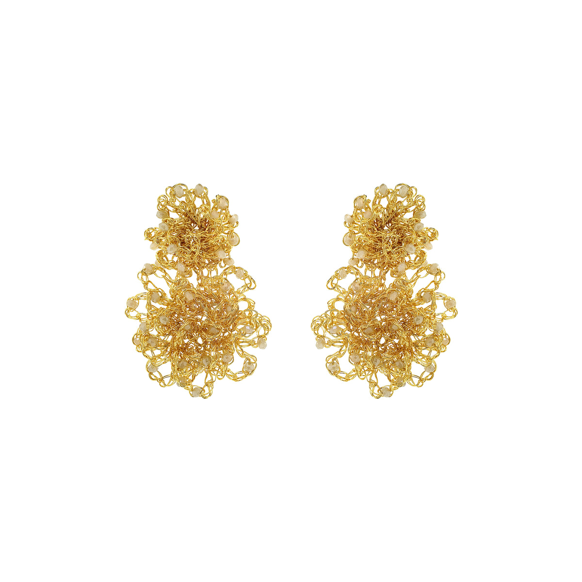 Pair of gold floral earrings on a white background. Hand-crocheted gold Double Mandala earrings with dimensional floral details and white pearl-like bead accents, handmade in Brazil.