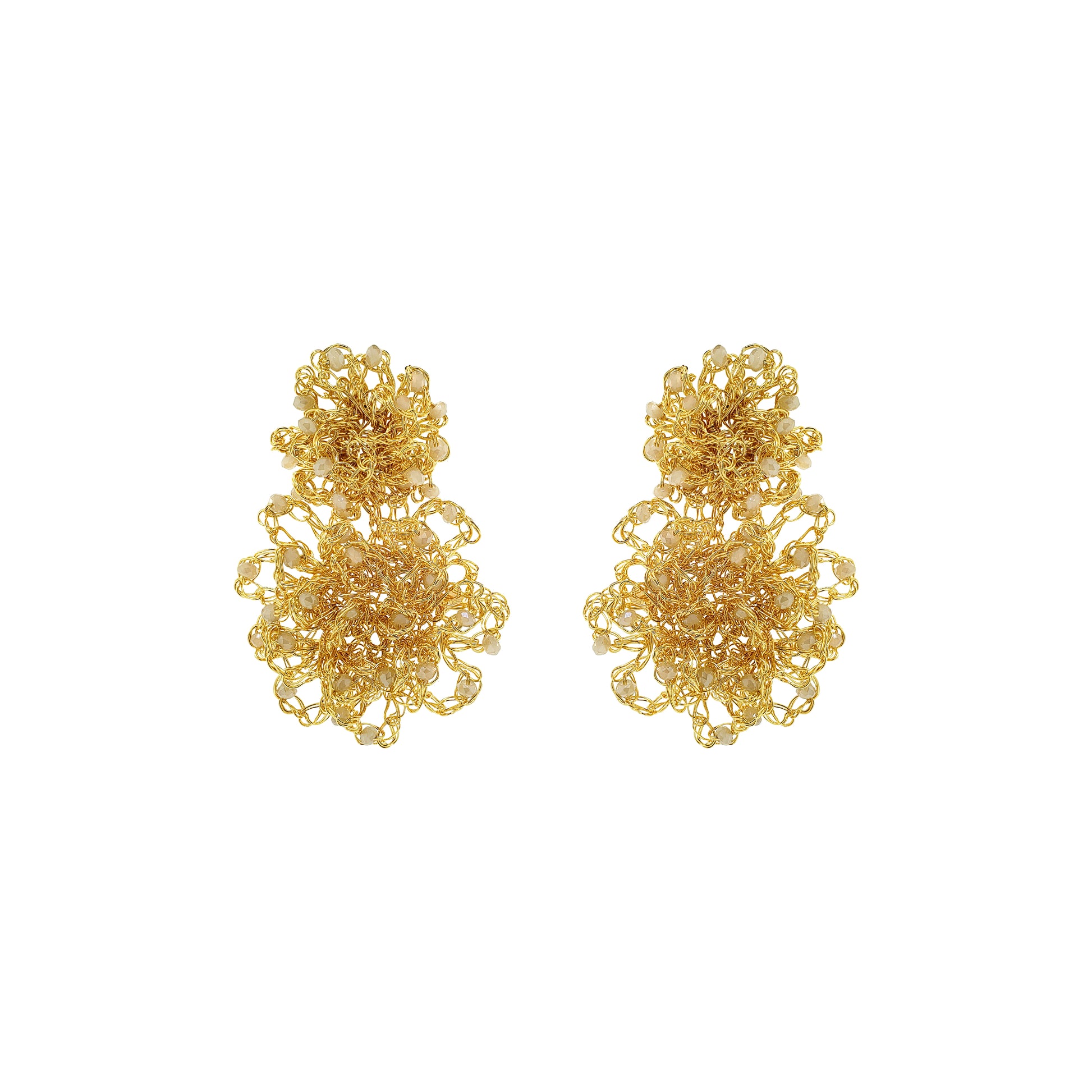 Pair of gold floral earrings on a white background. Hand-crocheted gold Double Mandala earrings with dimensional floral details and white pearl-like bead accents, handmade in Brazil.