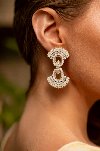Close-up of a person wearing a sparkling earring with a blurred background